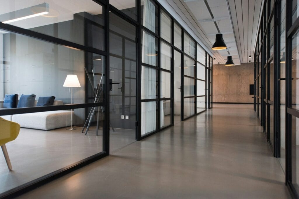 Photo by Nastuh Abootalebi hallway between glass-panel doors